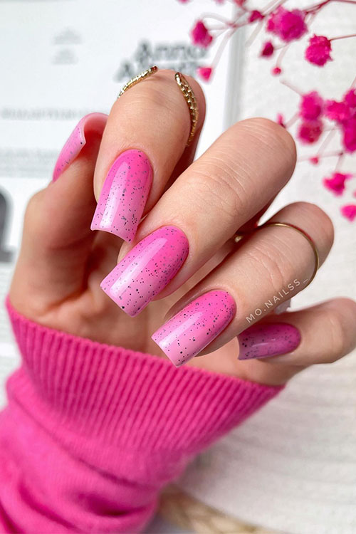 Long square-shaped hot to light pink ombre easter nails with black specks