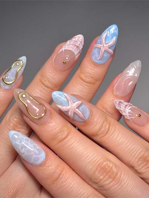 Beautiful ocean-themed nails with intricate seashells, starfish, and shimmering accents in calming blue and pink hues. Beautiful ocean-themed nails with intricate seashells, starfish, and shimmering accents in calming blue and pink hues.