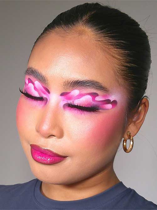 Bold pink makeup look featuring creative shades, voluminous false eyelashes, and a vibrant pink lip, exuding confidence. Bold pink makeup look featuring creative shades, voluminous false eyelashes, and a vibrant pink lip, exuding confidence.