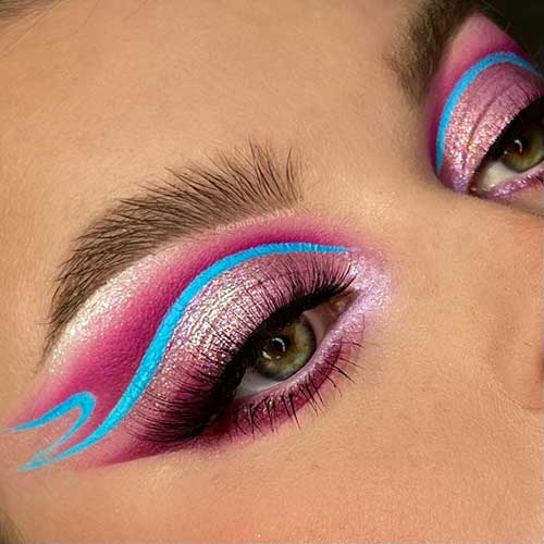 Captivating eye makeup showcasing silver and pink eyeshadow, paired with vibrant blue eyeliner for a bold, creative style. Captivating eye makeup showcasing silver and pink eyeshadow, paired with vibrant blue eyeliner for a bold, creative style.