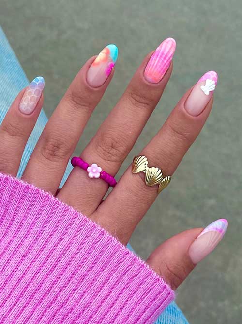 Colorful seashell-inspired nails with honeycomb patterns, pastel French tips, and 3D seashell accents for a summer vibe. Colorful seashell-inspired nails with honeycomb patterns, pastel French tips, and 3D seashell accents for a summer vibe.