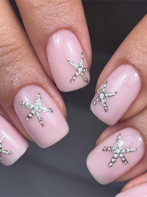 Dazzling starfish nails with a soft pink base, embellished with silver and white rhinestones, perfect for a seaside-inspired style. Dazzling starfish nails with a soft pink base, embellished with silver and white rhinestones, perfect for a seaside-inspired style.