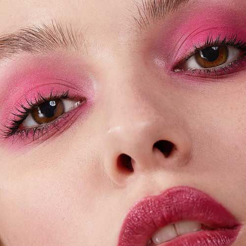 Dreamy pink eyeshadow and lipstick create a whimsical, monochromatic makeup look with fresh skin and natural brows. Dreamy pink eyeshadow and lipstick create a whimsical, monochromatic makeup look with fresh skin and natural brows.