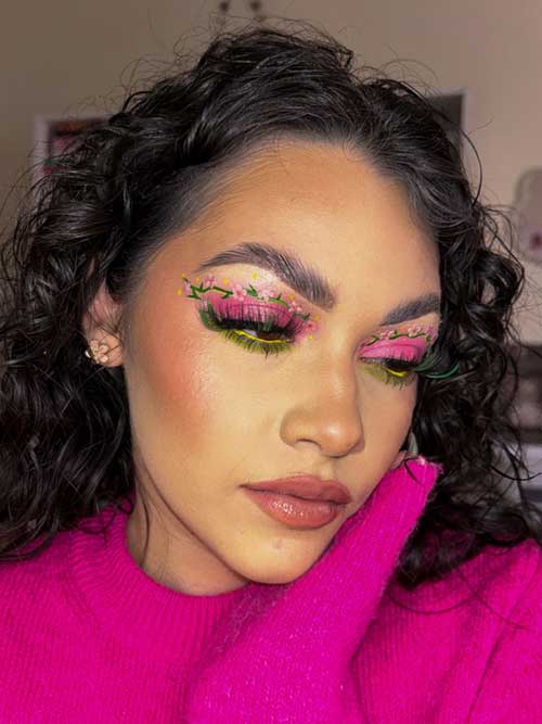 Floral-inspired makeup features hand-painted flowers on soft pink eyeshadow, green eyeliner, and a fresh, dewy complexion. Floral-inspired makeup features hand-painted flowers on soft pink eyeshadow, green eyeliner, and a fresh, dewy complexion.