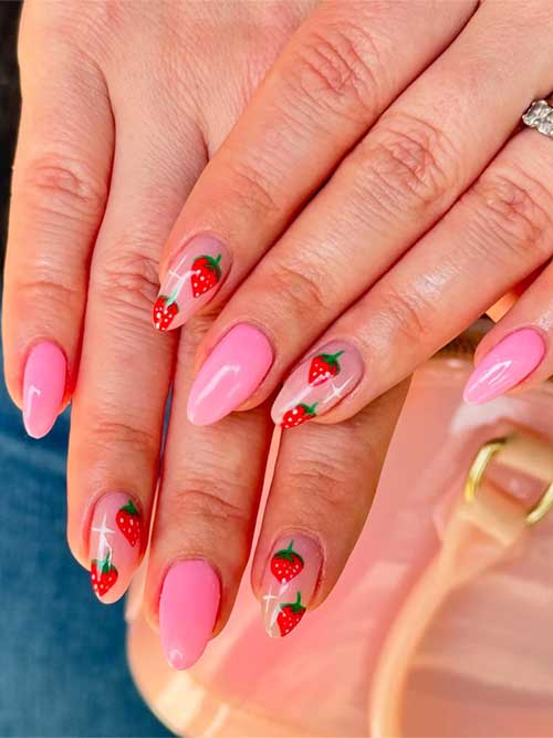 Glossy pink and nude almond-shaped nails with tiny strawberries and green leaves, creating a cheerful, fruity manicure. Glossy pink and nude almond-shaped nails with tiny strawberries and green leaves, creating a cheerful, fruity manicure.