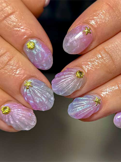 Iridescent seashell-inspired nails in purple, pink, and white with 3D seashells and gold starfish charms for a whimsical summer look. Iridescent seashell-inspired nails in purple, pink, and white with 3D seashells and gold starfish charms for a whimsical summer look.
