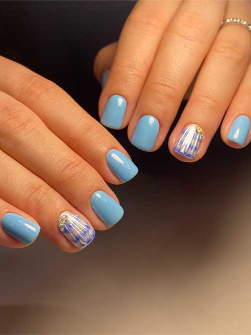 Light blue manicure with glossy finish, seashell accents, and gold rhinestones, perfect for summer beach vibes. Light blue manicure with glossy finish, seashell accents, and gold rhinestones, perfect for summer beach vibes.