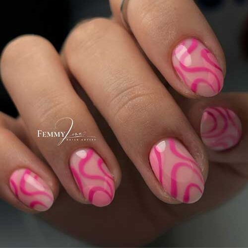 Light pink nails with rich pink swirls, resembling cotton candy, create a playful and whimsical design for a sweet look.