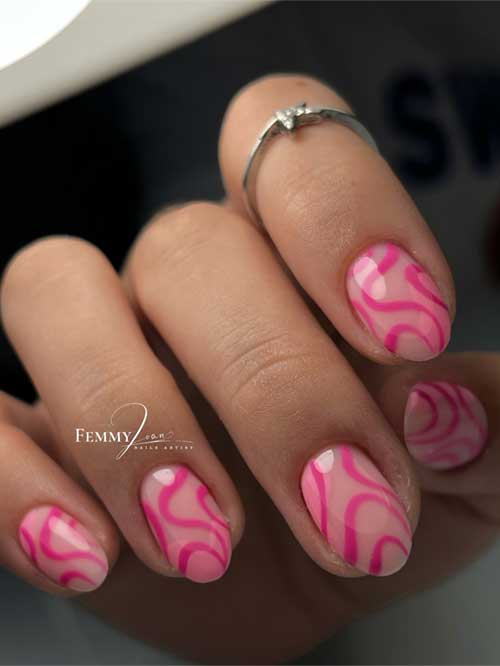 Light pink nails with rich pink swirls, resembling cotton candy, create a playful and whimsical design for a sweet look. Light pink nails with rich pink swirls, resembling cotton candy, create a playful and whimsical design for a sweet look.