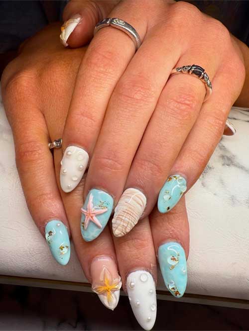 Ocean-inspired nails with intricate seashells, starfish, and pearl details, capturing the essence of beach beauty. Ocean-inspired nails with intricate seashells, starfish, and pearl details, capturing the essence of beach beauty.