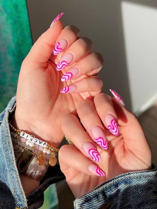 Pink swirl nails on a nude base, showcasing vibrant, abstract designs for a playful and chic retro-inspired look. Pink swirl nails on a nude base, showcasing vibrant, abstract designs for a playful and chic retro-inspired look.