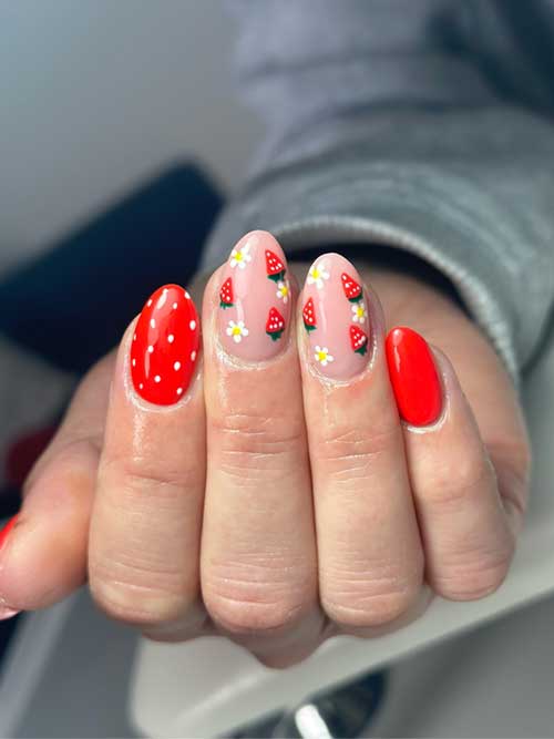 Strawberry-themed manicure with glossy red and nude pink nails, featuring tiny strawberries and green leaves for a playful look. Strawberry-themed manicure with glossy red and nude pink nails, featuring tiny strawberries and green leaves for a playful look.