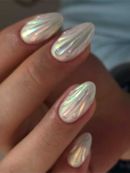 Stunning seashell-inspired almond nails in pearlescent white, shimmering beautifully, capturing the essence of ocean serenity. Stunning seashell-inspired almond nails in pearlescent white, shimmering beautifully, capturing the essence of ocean serenity.