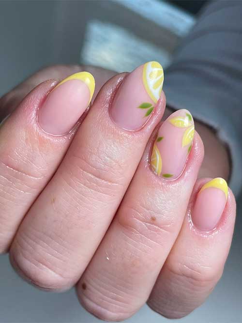 Bright fruit nails French tip featuring blush pink base, yellow French tips, and hand-drawn lemon slices with green leaves. Bright fruit nails French tip featuring blush pink base, yellow French tips, and hand-drawn lemon slices with green leaves.