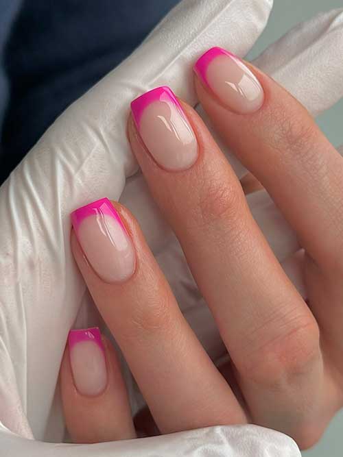 Chic short nails with a French manicure twist, showcasing white tips and a bold pink pop for a stylish and sophisticated look. Chic short nails with a French manicure twist, showcasing white tips and a bold pink pop for a stylish and sophisticated look.