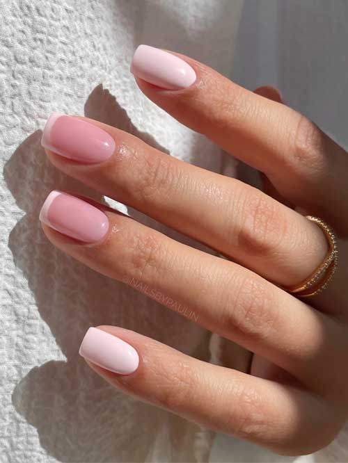 Chic short pastel pink nails with delicate French tips, blending soft pink and white for a sophisticated, feminine look. Chic short pastel pink nails with delicate French tips, blending soft pink and white for a sophisticated, feminine look.
