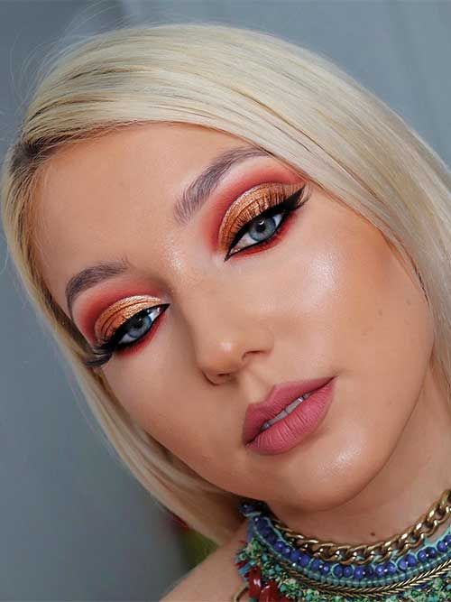 Dazzling copper-orange glitter eyeshadow for blue eyes, paired with warm terracotta and bold winged eyeliner. Dazzling copper-orange glitter eyeshadow for blue eyes, paired with warm terracotta and bold winged eyeliner.