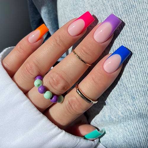 French Multicolor nails with a nude pink base and vibrant color-tipped square nails, perfect for summer fun and style.
