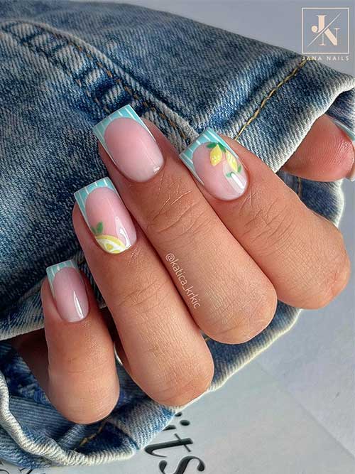 Fruit nails French tip with milky pink base, light blue tips, white stripes, and hand-painted lemons on ring and index fingers. Fruit nails French tip with milky pink base, light blue tips, white stripes, and hand-painted lemons on ring and index fingers.