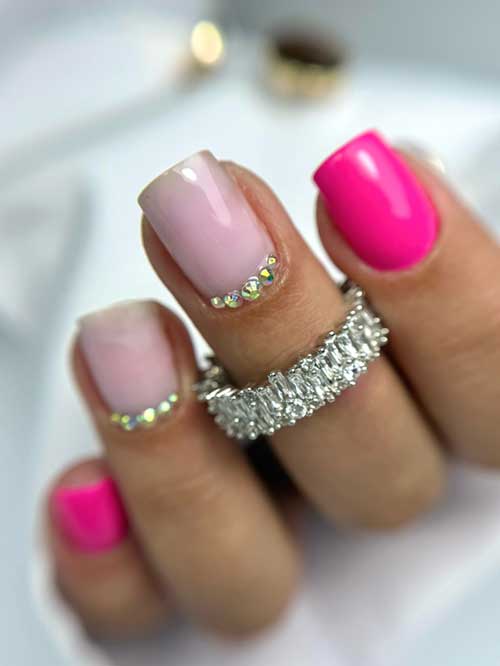 Hot pink nails with chic nude accents and sparkling rhinestones, blending boldness and elegance for a glamorous look. Hot pink nails with chic nude accents and sparkling rhinestones, blending boldness and elegance for a glamorous look.