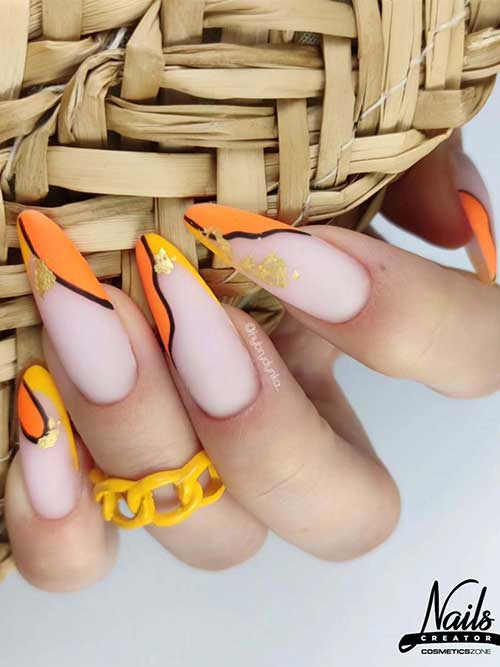 Matte yellow and orange nails with black lines and gold leaf accents on a nude base, radiating warmth and elegance. Matte yellow and orange nails with black lines and gold leaf accents on a nude base, radiating warmth and elegance.