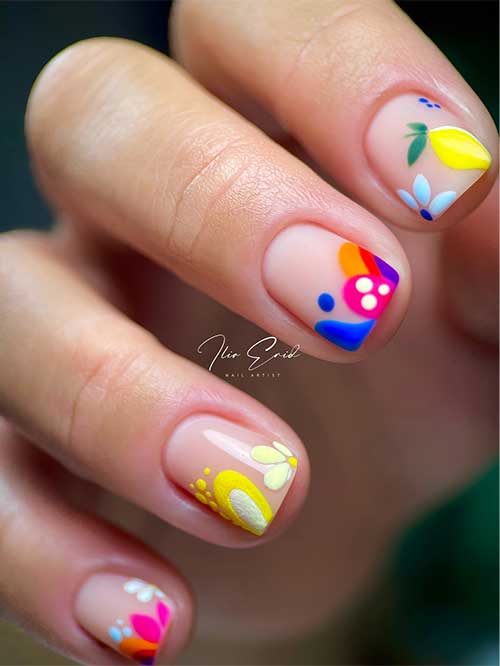 Short funky nails with a nude base feature vibrant abstract art, including a cactus under a sun and colorful patterns.