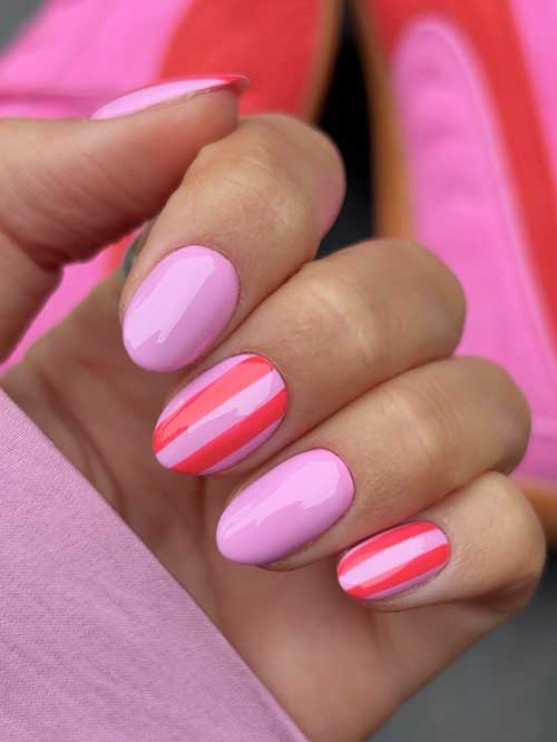 Short pink nails featuring bold deeper pink stripes, offering a whimsical touch to brighten your day and style. Short pink nails featuring bold deeper pink stripes, offering a whimsical touch to brighten your day and style.