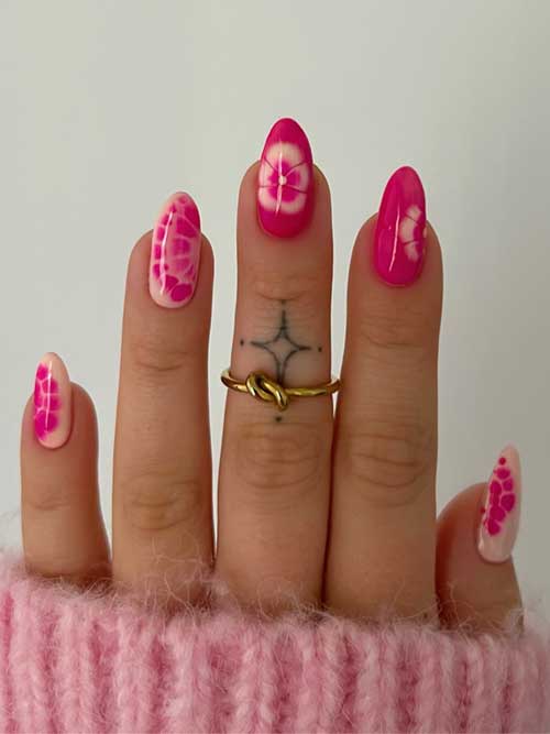 Stylish pink almond nails showcasing a tie-dye effect and floral details, perfect for elevating your everyday look with flair. Stylish pink almond nails showcasing a tie-dye effect and floral details, perfect for elevating your everyday look with flair.