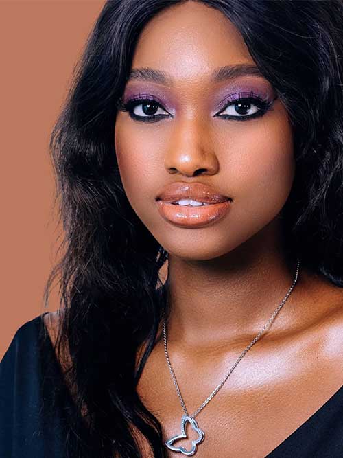 Deep purple eyeshadow enhances the model's features, paired with defined eyeliner and nude lips for a glamorous look. Deep purple eyeshadow enhances the model's features, paired with defined eyeliner and nude lips for a glamorous look.