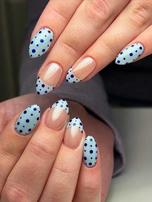 Dreamy pastel blue nails with navy polka dots and French tips, creating a charming and polished springtime look. Dreamy pastel blue nails with navy polka dots and French tips, creating a charming and polished springtime look.