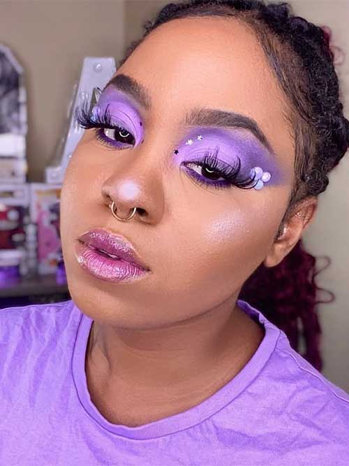 Dreamy purple eyeshadow with light and dark shades, adorned with stars and flowers, paired with dramatic lashes and glossy lips. Dreamy purple eyeshadow with light and dark shades, adorned with stars and flowers, paired with dramatic lashes and glossy lips.