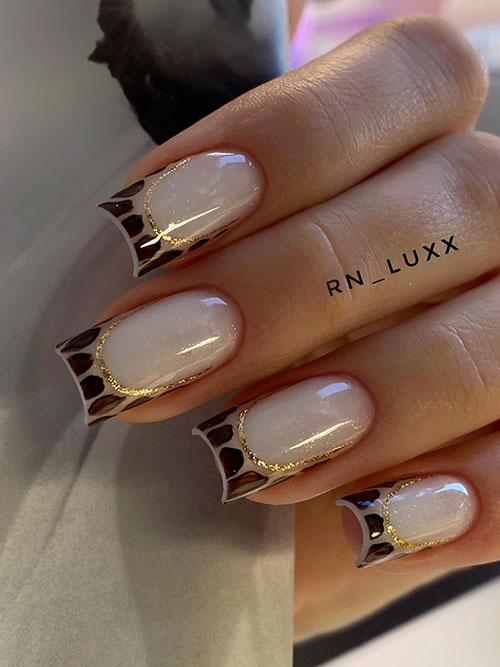 Elegant animal print French manicure with nude shimmer base, brown and black tips, and a gold line for a polished look.