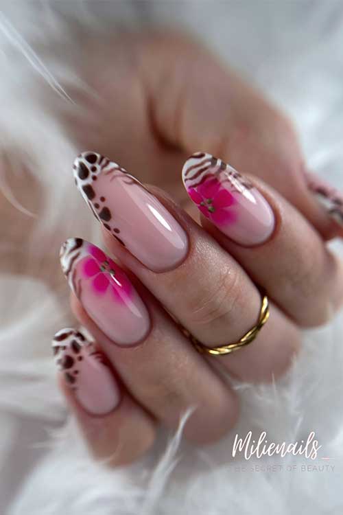 Stylish nude French manicure featuring dramatic leopard and zebra tips, with delicate pink floral designs for added flair.