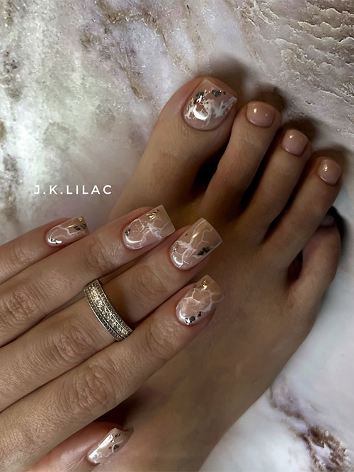 Elegant nude manicure and pedicure with white marble swirls and silver flakes, perfect for weddings or business meetings.