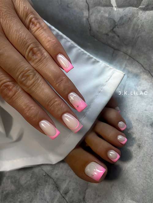 Heart-accented manicure and pedicure set with nude bases, pink tips, and rhinestones, perfect for romantic occasions.