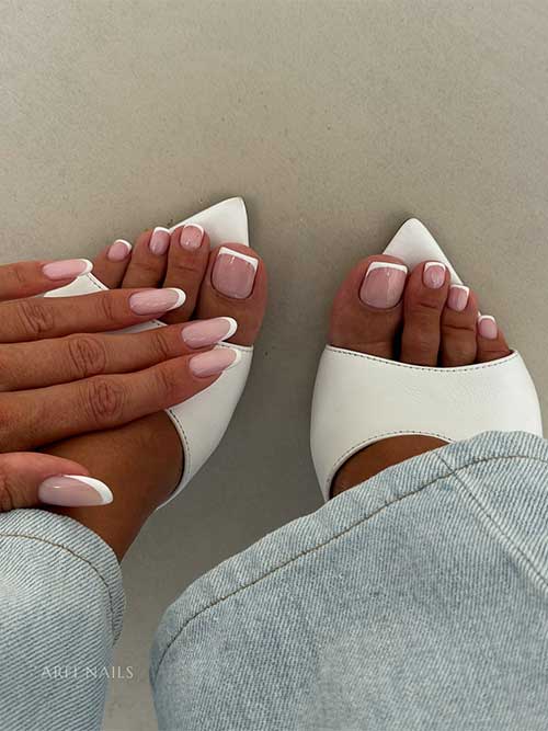 Timeless soft pink manicure and pedicure with white French tips, featuring almond-shaped fingernails and square toenails.
