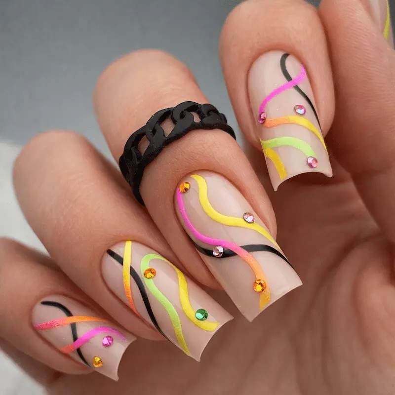 Multicolored neon swirls nails that feature long square-shaped nude nails with neon swirls