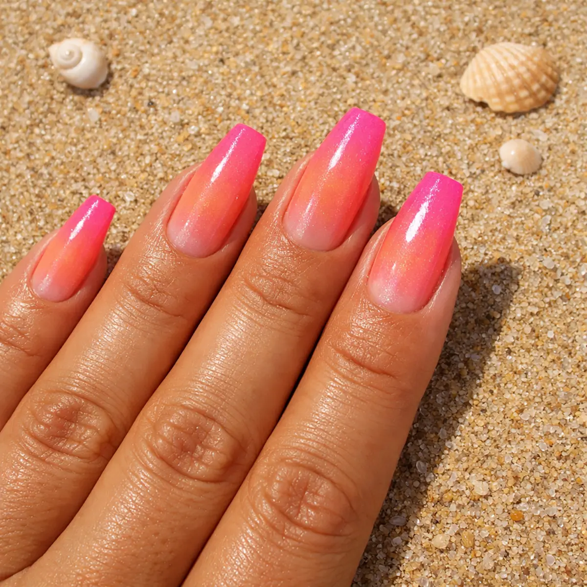 The kind of nails that make you want to book a flight somewhere warm — coral melting into neon pink, straight summer energy