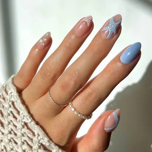Starfish Fake Nails in short almond shape with 3D starfish design, pearl accents, seashell art, soft nude base, and glossy pastel blue nail for a beach-inspired summer manicure.