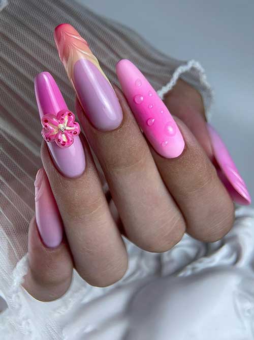 Dreamy pink ombre nails with 3D flower, water droplet accents, and feather design, showcasing creativity and femininity.