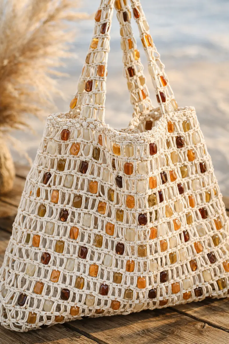 Stylish boho crochet beach bag handbag with colorful beads, perfect for summer beach trips and as a lightweight travel organizer.