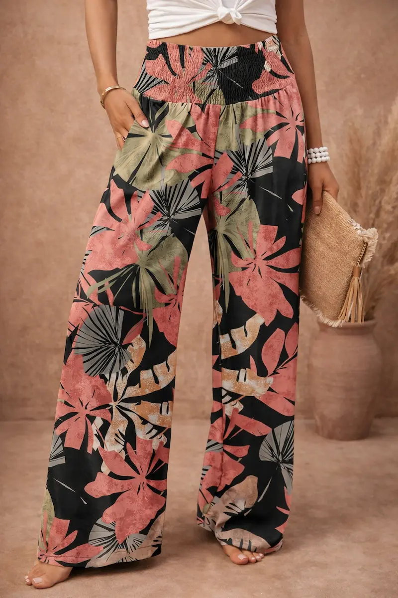 Angerella elastic high-waisted tropical-print palazzo pants in pink black and green leaf pattern, on model