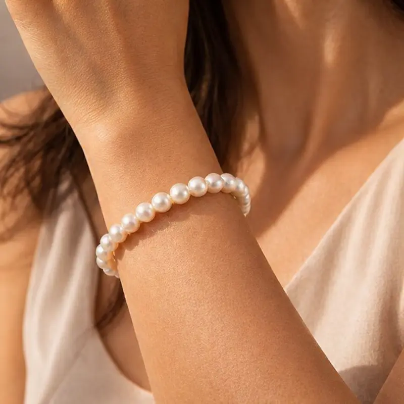 Sheplus freshwater pearl bracelet with 925 sterling silver toggle closure on a womans wrist in natural light
